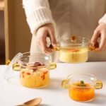 ⁦Mini Glass Cooking Pot with Glass Lid and Handle - Transparent Heat Resistant Glass for Daily Use - Capacity 300ml⁩ - الصورة ⁦2⁩